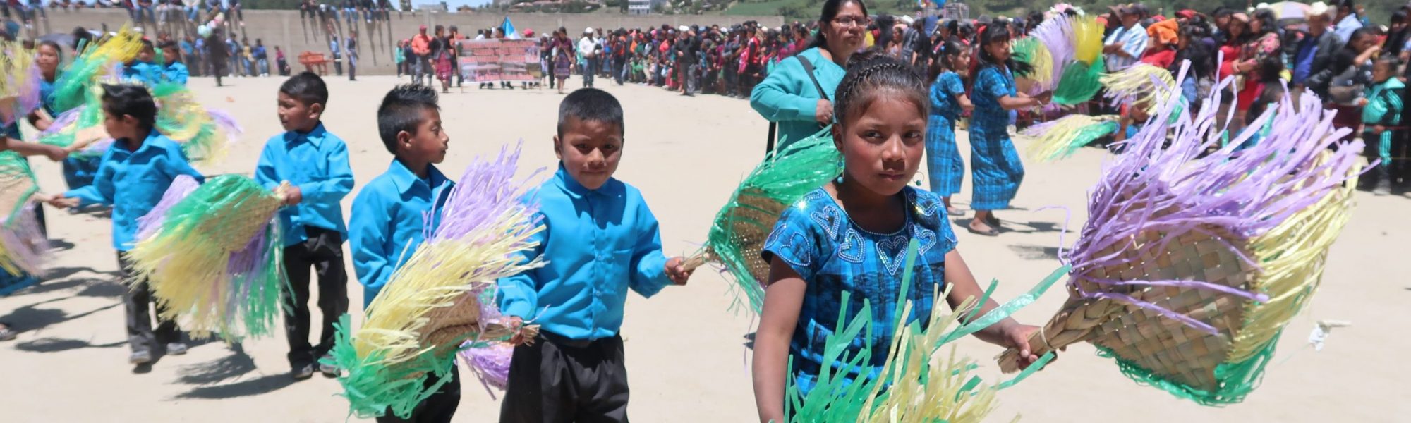 children holding colorful fans
