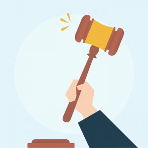 A hand holding a gavel