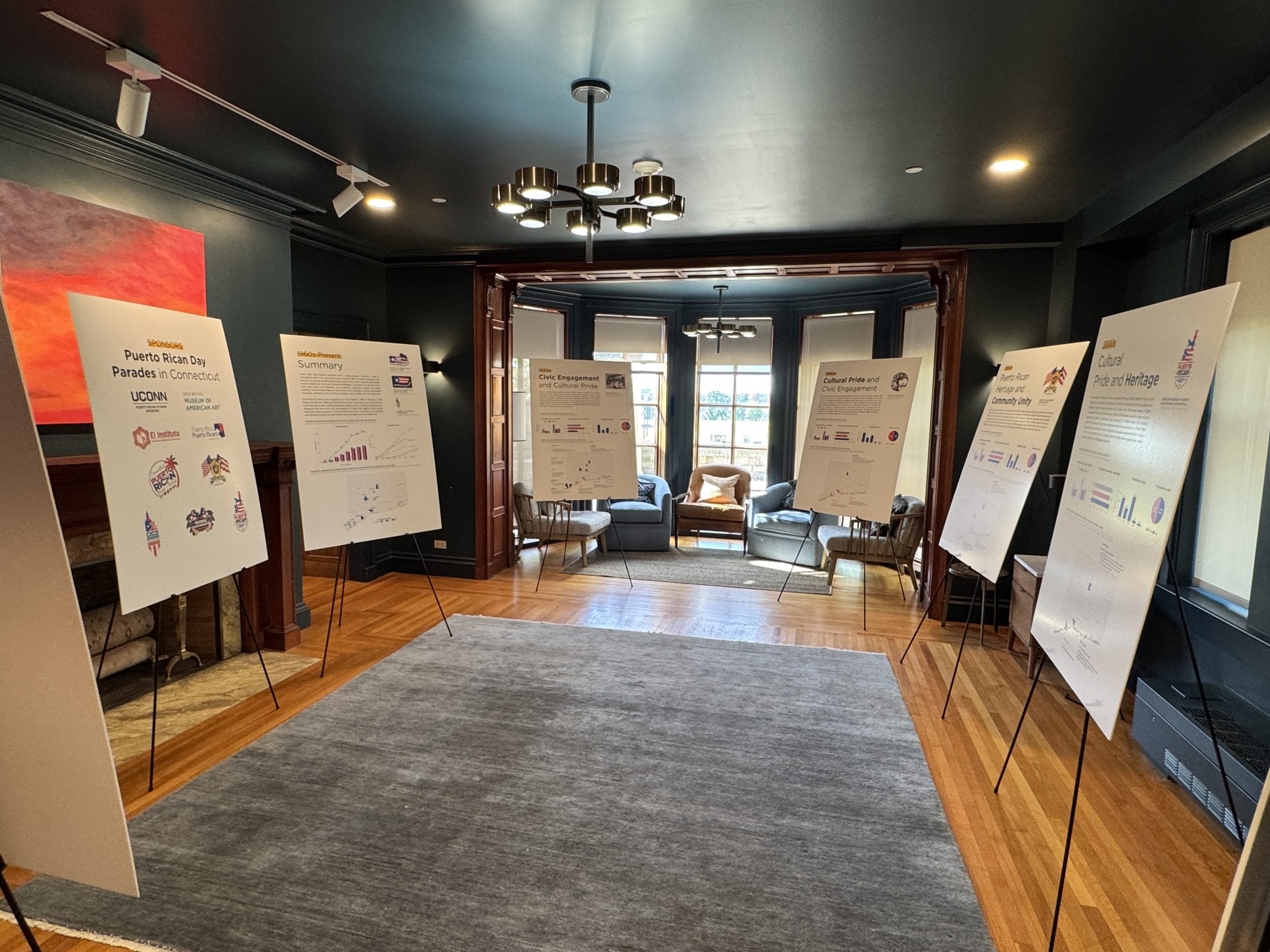 A room featuring multiple posters on the walls, showcasing various artistic designs and vibrant colors.
